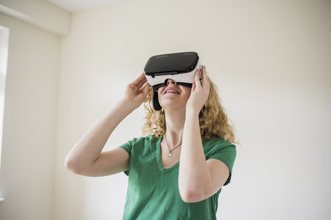 Woman wearing VR glasses looking up stock photo