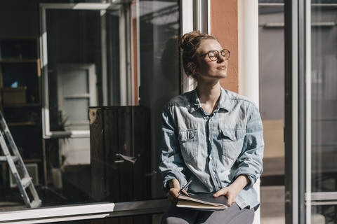 Young woman with glasses in sunlight stock photo