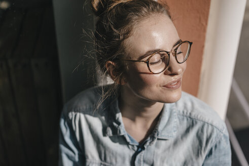Young woman with glasses in sunlight - KNSF01467