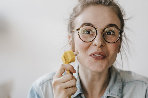 Portrait of young woman with power cable - KNSF01485