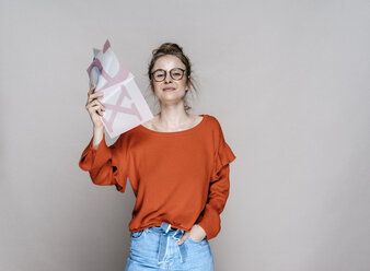 Portrait of young woman holding letter x template - KNSF01507