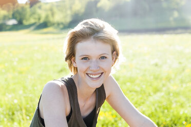 Porträt einer lächelnden jungen Frau in der Natur - TCF05420