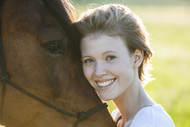 Portrait of happy of young woman with horse - TCF05425