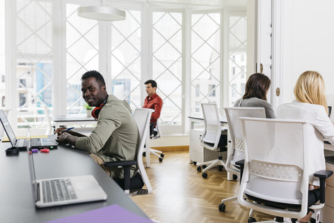 Junge Menschen, die in einem Start-up-Unternehmen arbeiten, lizenzfreies Stockfoto