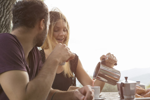 Couple having breakfast outdoors stock photo