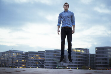 Portrait of young man jumping in the air - JOSF01044