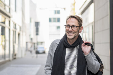 Portrait of smiling mature man with stubble and glasses - FMKF04153