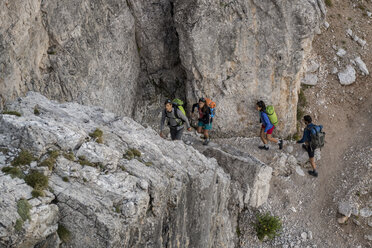 Italy, Friends climbing rocks in the Dolomites - ZOCF00474