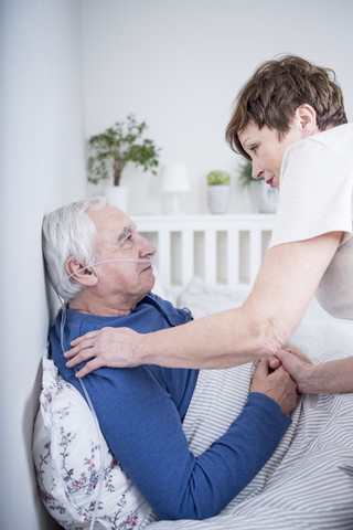 Wife taking care of her ill husband stock photo