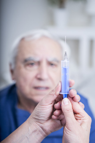 Nurse preparing injection for patient stock photo