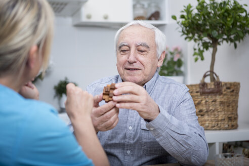 Gereatric nurse doing dexterity games with elderly patient - WESTF23374