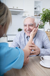 Gereatric nurse listening to elderly patient - WESTF23387