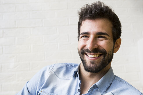 Portrait of laughing young man with beard - ABZF02044