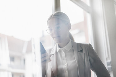 Portrait of businesswoman using cell phone - JOSF01058
