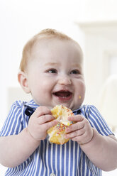 Porträt eines glücklichen kleinen Jungen mit Muffin - FSF00922