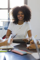 Portrait of smiling businesswoman during a meeting in office - GIOF02647