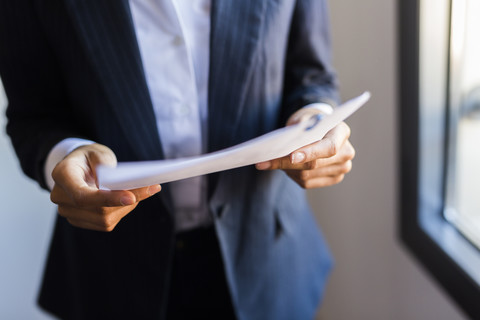 Close-up of businesswoman holding document stock photo