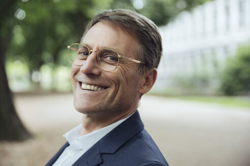 Portrait of smiling mature businessman outdoors - MFF03615
