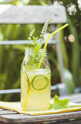 Glass of ice-cooled homemade lime cucumber lemonade with mint leaves - GWF05233