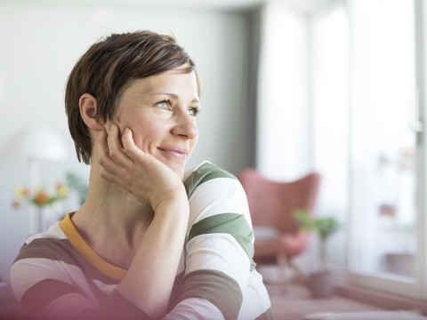 Portrait of smiling woman at home stock photo
