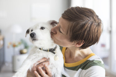 Woman kissing her dog - RBF05701