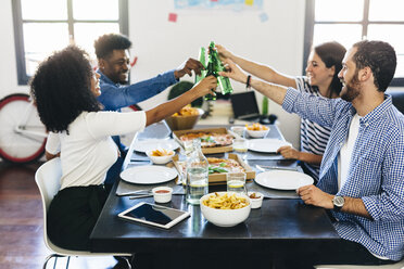 Group of friends having pizza and beer at home - GIOF02736