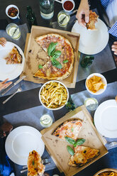Friends having pizza and French fries - GIOF02749