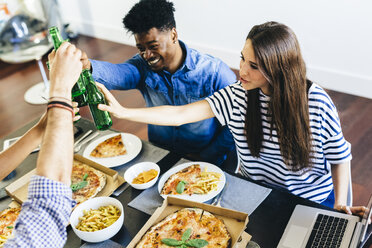 Group of friends having pizza and beer at home - GIOF02776