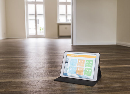 Tablet mit Smart-Home-Anwendungen auf Holzboden - UUF10831