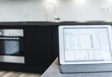 Tablet with floor plan on kitchen counter - UUF10832