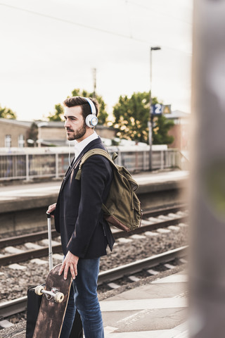 Junger Mann wartet auf dem Bahnsteig, lizenzfreies Stockfoto