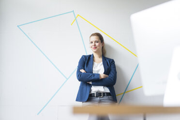 Businesswoman standing in office with arms crossed - JOSF01151