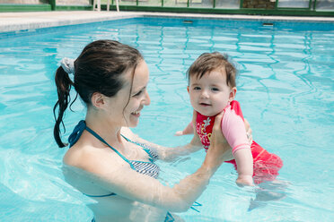 Cute baby girl learning to swim in the pool with her mother - GEMF01678