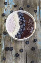 Bowl of yoghurt with blueberry mush, coconut flakes and blueberries - ODF01524