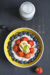 Bowl of spelt pops with blueberries, strawberries, bananas and coconut flakes - ODF01528