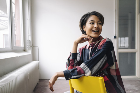 Smiling woman sitting on chair stock photo