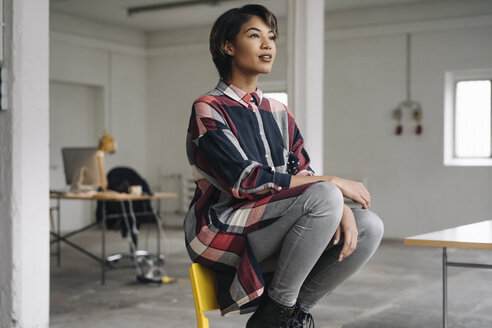 Woman sitting on chair thinking - KNSF01531