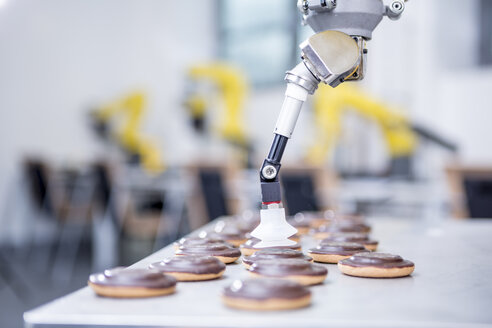 Close-up of industrial robot handling cookies - WESTF23426