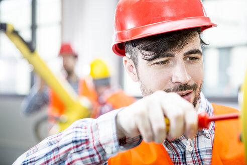 Technician working on industrial robot - WESTF23461