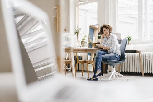 Geschäftsfrau im Büro mit Smartphone - KNSF01584