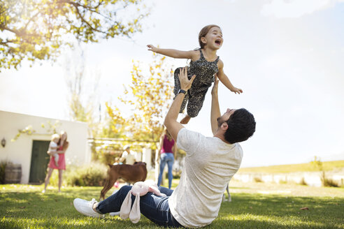 Father playing with daughter in garden - ZEF13940