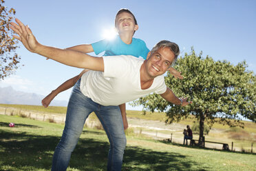 Father playing with son in garden - ZEF13954