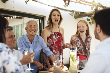 Glückliche Familie beim gemeinsamen Mittagessen im Freien - ZEF13969