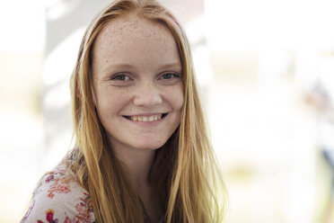 Portrait of smiling girl with long red hair - ZEF13987