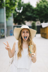 Woman with discolored tongue holding ice cream cone - JPF00217