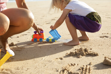 Spain, Fuerteventura, mother and daughter playing on the beach - MFRF00868