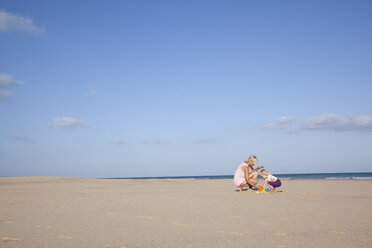 Spain, Fuerteventura, mother and daughter playing on the beach - MFRF00870