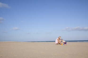 Spanien, Fuerteventura, Mutter und Tochter spielen am Strand - MFRF00870