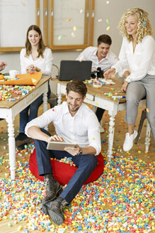 Creative professionals meeting in office surrounded by colorful polystyrene parts - PESF00635