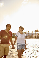 Couple in love walking hand in hand on the beach - PACF00002